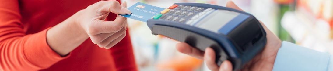 Consumer buying item with a credit card at a small business
